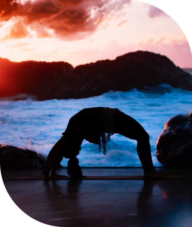 woman doing yoga backbend in front of ocean LED screen