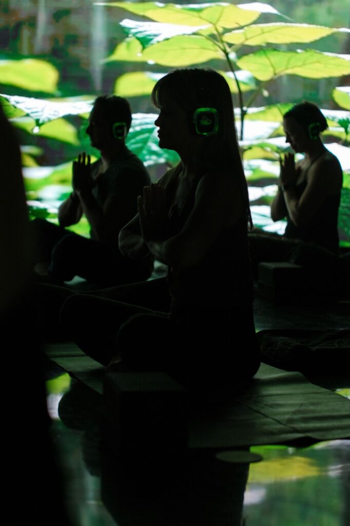 Modern yoga class at Namaste Yoga Scottsdale featuring immersive cinematic visuals and infrared heated wellness experience.